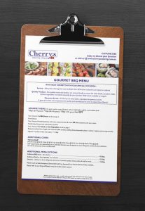 Cherry's gourmet BBQ catering menu on clipboard