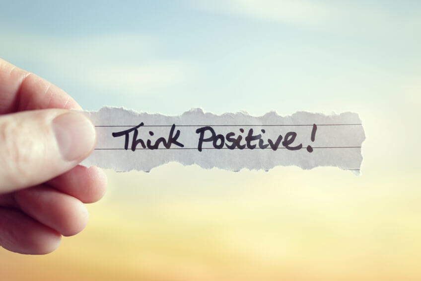 Think positive! written on piece of paper