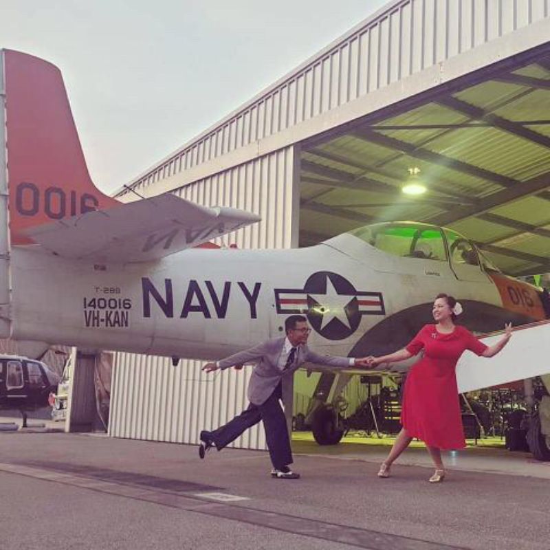 Couple and plane at Shani's Hanger Party with custom catering from Cherry's