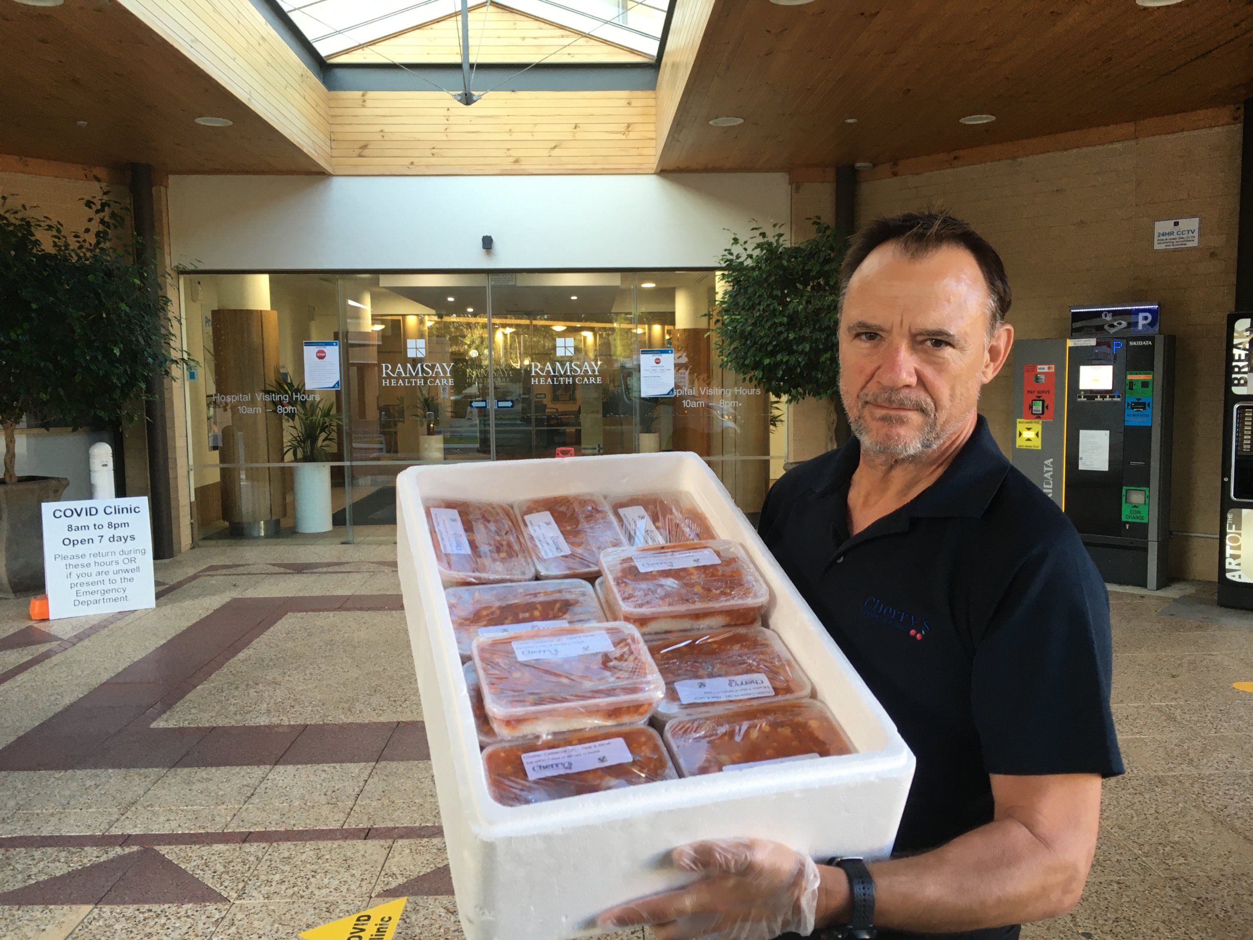 Craig with a box of complimentary frontline staff meals from Cherry's Catering for Joondalup Health Campus staff